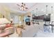 Open-concept living space with a kitchen bar, tile flooring, and a comfortable layout at 12851 24Th Street E Cir, Parrish, FL 34219