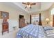Comfortable main bedroom featuring a trey ceiling, fan, and a well-lit interior at 12851 24Th Street E Cir, Parrish, FL 34219