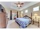 Inviting main bedroom with tray ceiling, four-poster bed, and ample natural light at 12851 24Th Street E Cir, Parrish, FL 34219