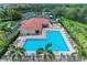Bright community pool area with lounge chairs and tiled roof cabana, adjacent to tennis courts and playground at 12851 24Th Street E Cir, Parrish, FL 34219