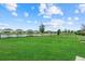 Beautiful backyard with well maintained lawn and a wrought iron fence overlooking a pond at 16419 Paynes Mill Dr, Bradenton, FL 34211