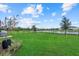 Well maintained backyard with green grass and a wrought iron fence overlooking the water at 16419 Paynes Mill Dr, Bradenton, FL 34211