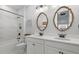 Modern bathroom featuring double sinks, decorative mirrors, and a sleek, minimalist design with a soaking tub at 16419 Paynes Mill Dr, Bradenton, FL 34211