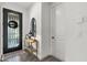 Bright entryway features a glass front door, console table, and security system for safety at 16419 Paynes Mill Dr, Bradenton, FL 34211