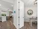 Hallway leading to an office space and open kitchen with dining and living room at 16419 Paynes Mill Dr, Bradenton, FL 34211