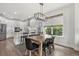 Open concept kitchen with white cabinets and stainless steel appliances leading to dining area at 16419 Paynes Mill Dr, Bradenton, FL 34211