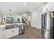 Bright kitchen with stainless steel appliances and large island sink overlooking the living space at 16419 Paynes Mill Dr, Bradenton, FL 34211
