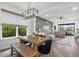 Open concept living and dining area with a large comfortable couch and wood-look flooring at 16419 Paynes Mill Dr, Bradenton, FL 34211
