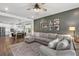 Open concept living area with a large comfortable couch, dining space, and an open kitchen at 16419 Paynes Mill Dr, Bradenton, FL 34211