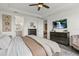 Main bedroom suite featuring tray ceiling, a ceiling fan, and ensuite bathroom at 16419 Paynes Mill Dr, Bradenton, FL 34211