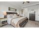 Comfortable main bedroom with a decorative headboard, ensuite bathroom, and warm color palette at 16419 Paynes Mill Dr, Bradenton, FL 34211