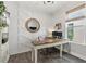 Stylish home office with unique wall details, wood floors, and a window for natural light at 16419 Paynes Mill Dr, Bradenton, FL 34211