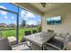 Screened patio features an outdoor dining set and a view of the pond at 16419 Paynes Mill Dr, Bradenton, FL 34211