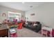 Spacious playroom with a comfortable sofa and shelving filled with toys, designed for fun and organization at 16419 Paynes Mill Dr, Bradenton, FL 34211