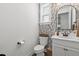 Charming powder room featuring a leaf-patterned wallpaper and vanity with storage space at 16419 Paynes Mill Dr, Bradenton, FL 34211