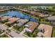Aerial view of homes surrounding a blue pond and green golf course in a beautiful community at 16511 Cornwall Ln, Lakewood Ranch, FL 34202