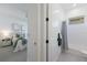 Bright bathroom featuring a tub with shower, white tile, and door leading to primary bedroom at 16511 Cornwall Ln, Lakewood Ranch, FL 34202
