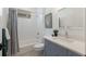 Bathroom features a vanity with gray cabinets, a quartz countertop, and a shower over tub at 16511 Cornwall Ln, Lakewood Ranch, FL 34202
