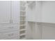 Walk-in closet featuring custom built-in storage shelves, drawers, and hanging rods at 16511 Cornwall Ln, Lakewood Ranch, FL 34202