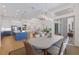 Open dining area with modern lighting, adjoining living spaces, and natural light at 16511 Cornwall Ln, Lakewood Ranch, FL 34202