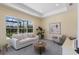 Comfortable living room with natural light, neutral decor, and views of the backyard at 16511 Cornwall Ln, Lakewood Ranch, FL 34202