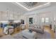 Bright living room with modern decor and open concept design into the kitchen at 16511 Cornwall Ln, Lakewood Ranch, FL 34202