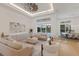 Bright and spacious living room with neutral decor, hardwood floors, and views of the backyard pool at 16511 Cornwall Ln, Lakewood Ranch, FL 34202