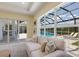 Bright living room with large windows offering a view of the pool and outdoor area at 16511 Cornwall Ln, Lakewood Ranch, FL 34202