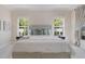 A bright main bedroom featuring a decorative headboard, matching side tables and plenty of natural light at 16511 Cornwall Ln, Lakewood Ranch, FL 34202