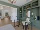 Stylish home office with built-in shelves and view of the dining room and backyard at 16511 Cornwall Ln, Lakewood Ranch, FL 34202