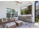 Outdoor kitchen with built-in grill, seating, and a ceiling fan at 16511 Cornwall Ln, Lakewood Ranch, FL 34202