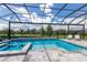 Beautiful pool area with a screened enclosure, blue tile and a spa at 16511 Cornwall Ln, Lakewood Ranch, FL 34202