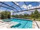 Sparkling pool and spa in a screened-in lanai with views of the water and sky at 16511 Cornwall Ln, Lakewood Ranch, FL 34202