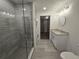 This bathroom features a glass enclosed shower, modern vanity, and laundry equipment at 1709 N Tamiami Trail # Ph 514, Sarasota, FL 34234
