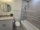 This bathroom features a shower-tub combo, modern vanity, and sleek fixtures at 1709 N Tamiami Trail # Ph 514, Sarasota, FL 34234