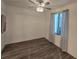 This bedroom features wood floors, a ceiling fan, and curtains with ample natural light at 1709 N Tamiami Trail # Ph 514, Sarasota, FL 34234