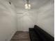 This bedroom features a sofa, double door closet, white trim, and wood floors at 1709 N Tamiami Trail # Ph 514, Sarasota, FL 34234