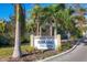 Community sign 'The Strand' with palm trees and well-maintained landscaping at the entrance at 1709 N Tamiami Trail # Ph 514, Sarasota, FL 34234
