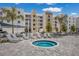 Outdoor hot tub surrounded by lounge chairs and palm trees, adjacent to modern condo buildings at 1709 N Tamiami Trail # Ph 514, Sarasota, FL 34234