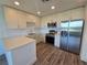 Clean-lined kitchen featuring stainless steel appliances and bright lighting at 1709 N Tamiami Trail # Ph 514, Sarasota, FL 34234