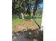 View of fence opening to grassy area with mature trees draped with moss at 201 Elliot Ave, Sarasota, FL 34232