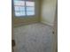 Bright bedroom featuring neutral walls, plush gray carpeting, and a window with blinds at 201 Elliot Ave, Sarasota, FL 34232