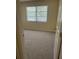 Bedroom view showcases new carpet and a large window at 201 Elliot Ave, Sarasota, FL 34232