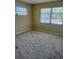 Cozy bedroom with three windows allowing for ample natural light and new carpet at 201 Elliot Ave, Sarasota, FL 34232