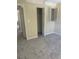 View of a bedroom showing a window with shutters, new carpet and a closet at 201 Elliot Ave, Sarasota, FL 34232
