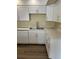 Bright kitchen with white cabinets, marble countertops, and modern stainless steel appliances at 201 Elliot Ave, Sarasota, FL 34232