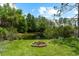 Relaxing backyard with a fire pit next to a pond at 21705 67Th E Ave, Bradenton, FL 34211