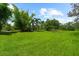 A sprawling green lawn features mature trees and ample space for outdoor activities at 21705 67Th E Ave, Bradenton, FL 34211