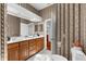 Bright bathroom with a double vanity, wood cabinets, and a toilet at 21705 67Th E Ave, Bradenton, FL 34211