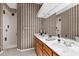 Well-lit bathroom featuring a double vanity, a large mirror and a walk-in shower at 21705 67Th E Ave, Bradenton, FL 34211